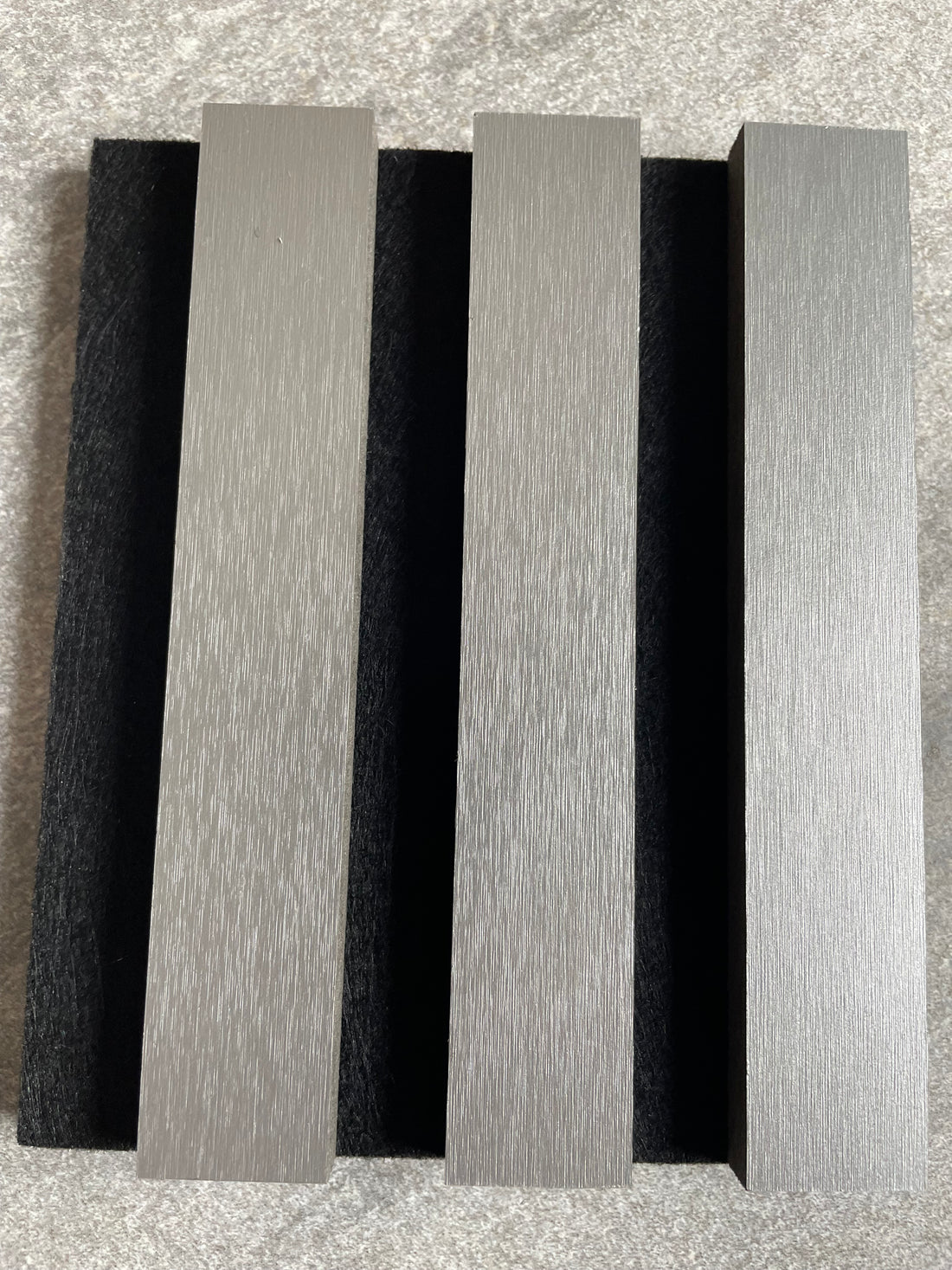 Acoustic Wall Panel 240x60cm - Metallic Light Grey - close-up sample showing the slats mounted on black acoustic felt